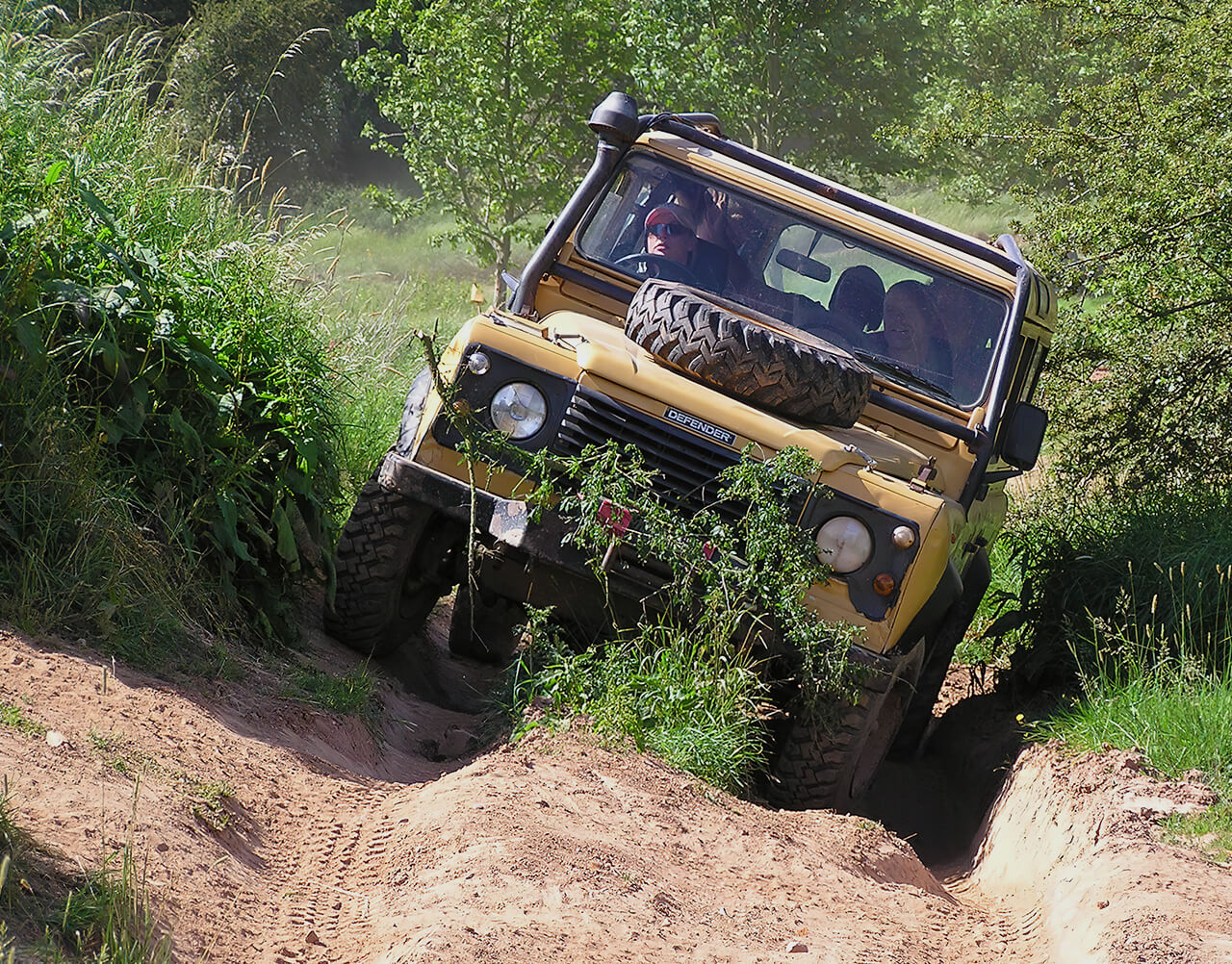 A Land Rover Defender going up rough terrain