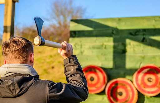 A man throwing an axe at some targets