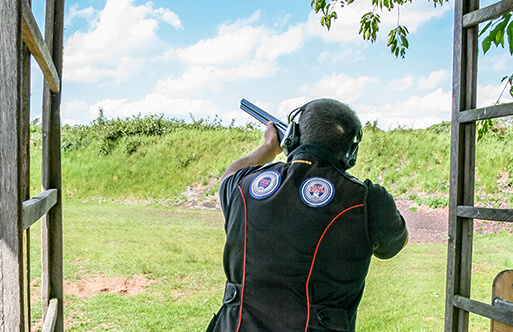 A man firing a shotgun at Wedgnock shooting grounds