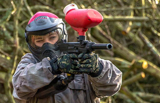 Someone aiming a paintball gun