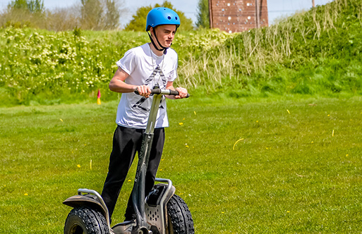 A boy riding a segway