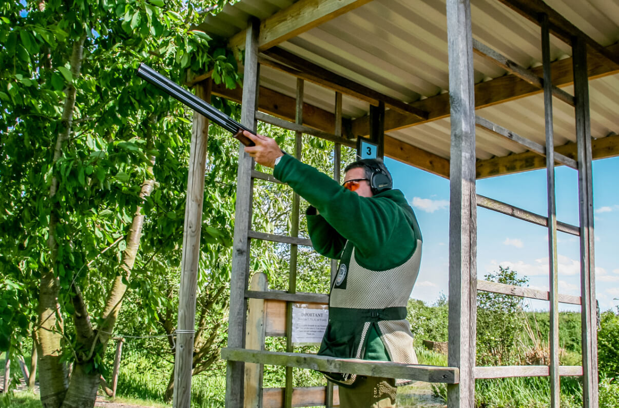 A group of women in a line, pulling back on a bow and arrow