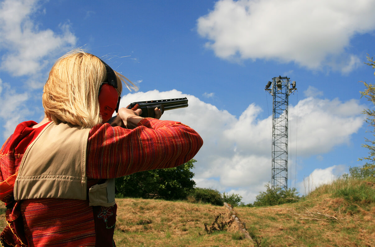 A woman aiming a rifle at Wedgnock shooting grounds
