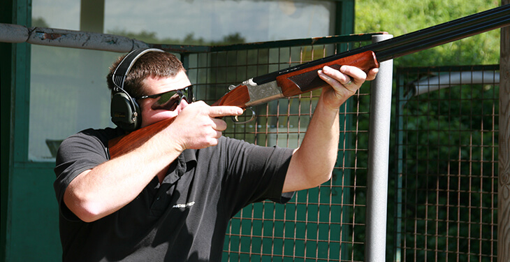 A man aiming a rifle at Wedgnock shooting grounds