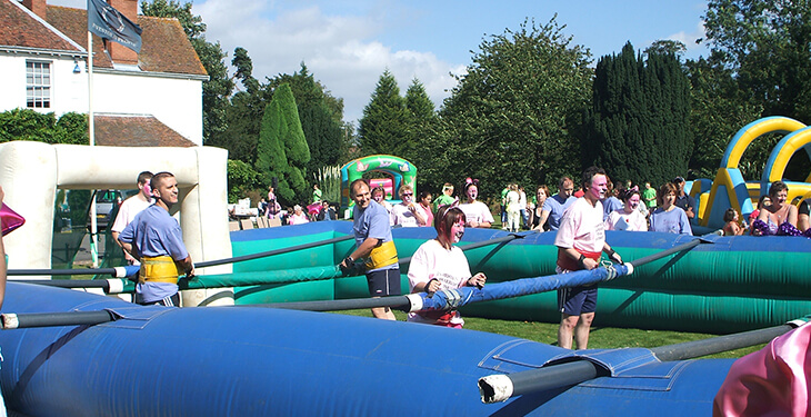 A large group of people working together the play human table football