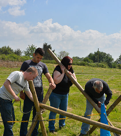 A group constructing a wooden structure together