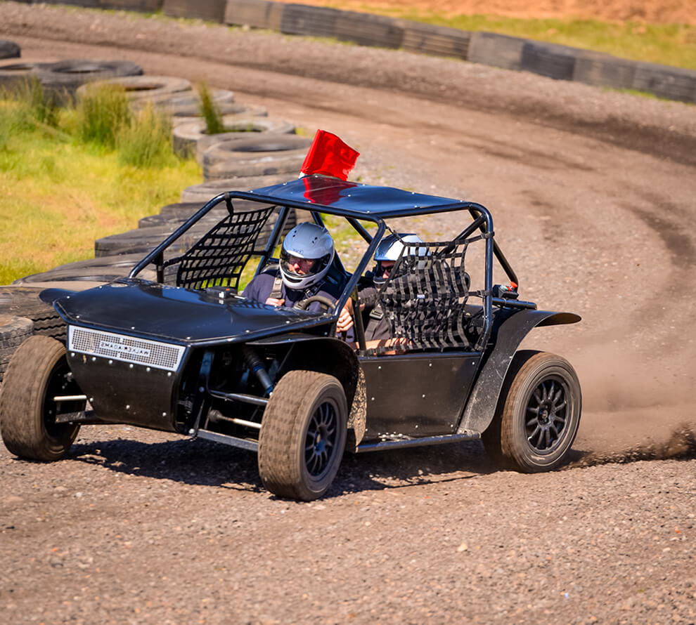 An off-road buggy driving around a track