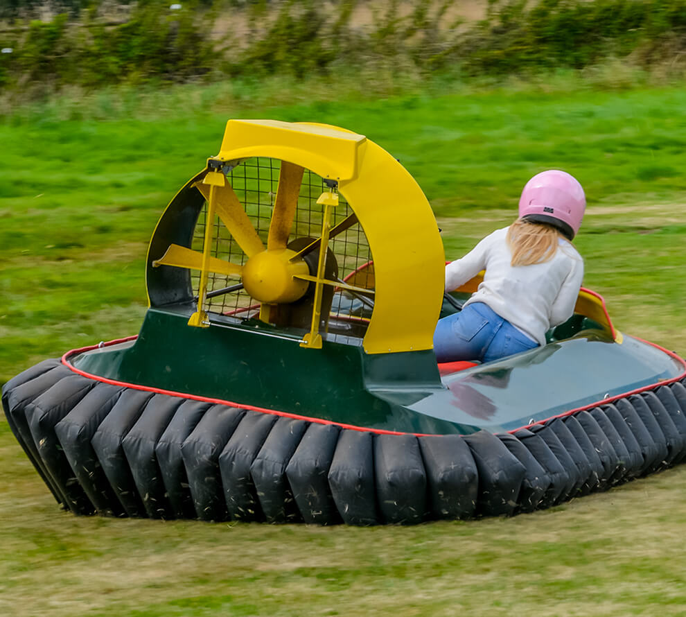 A lady leaning in a hovercraft to steer it