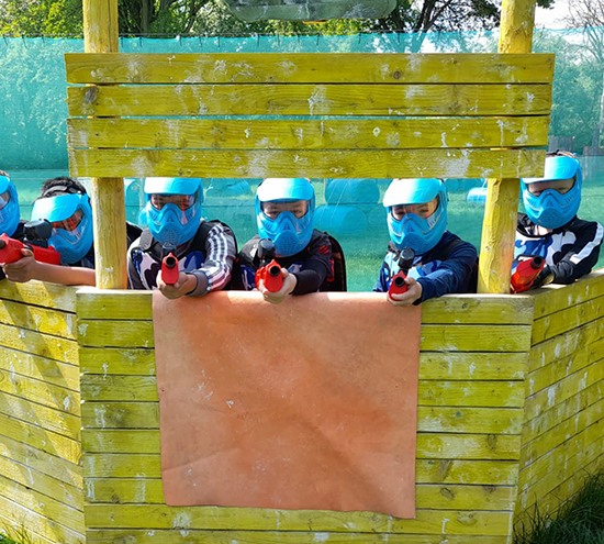 Many paintball guns stacked up neatly