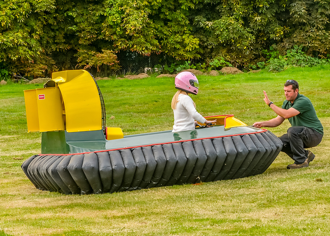 A woman learning how to drive a hovercraft