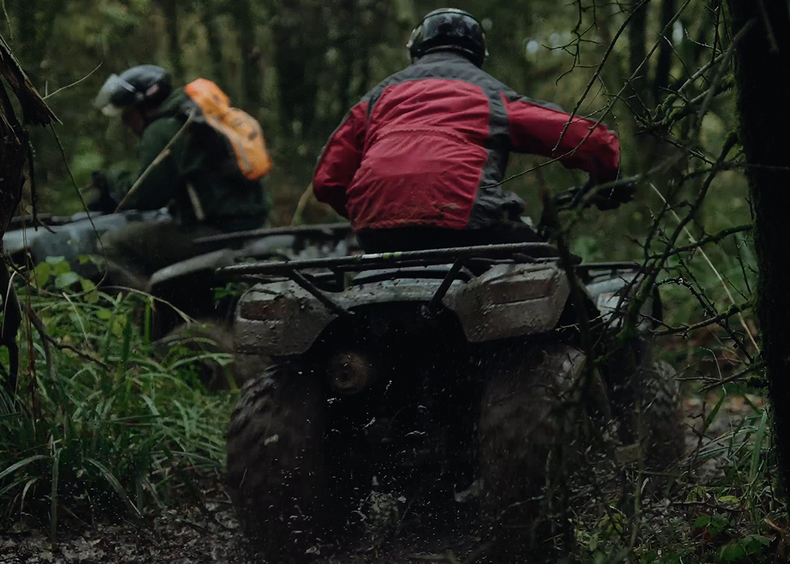 A man sat on a read quad bike