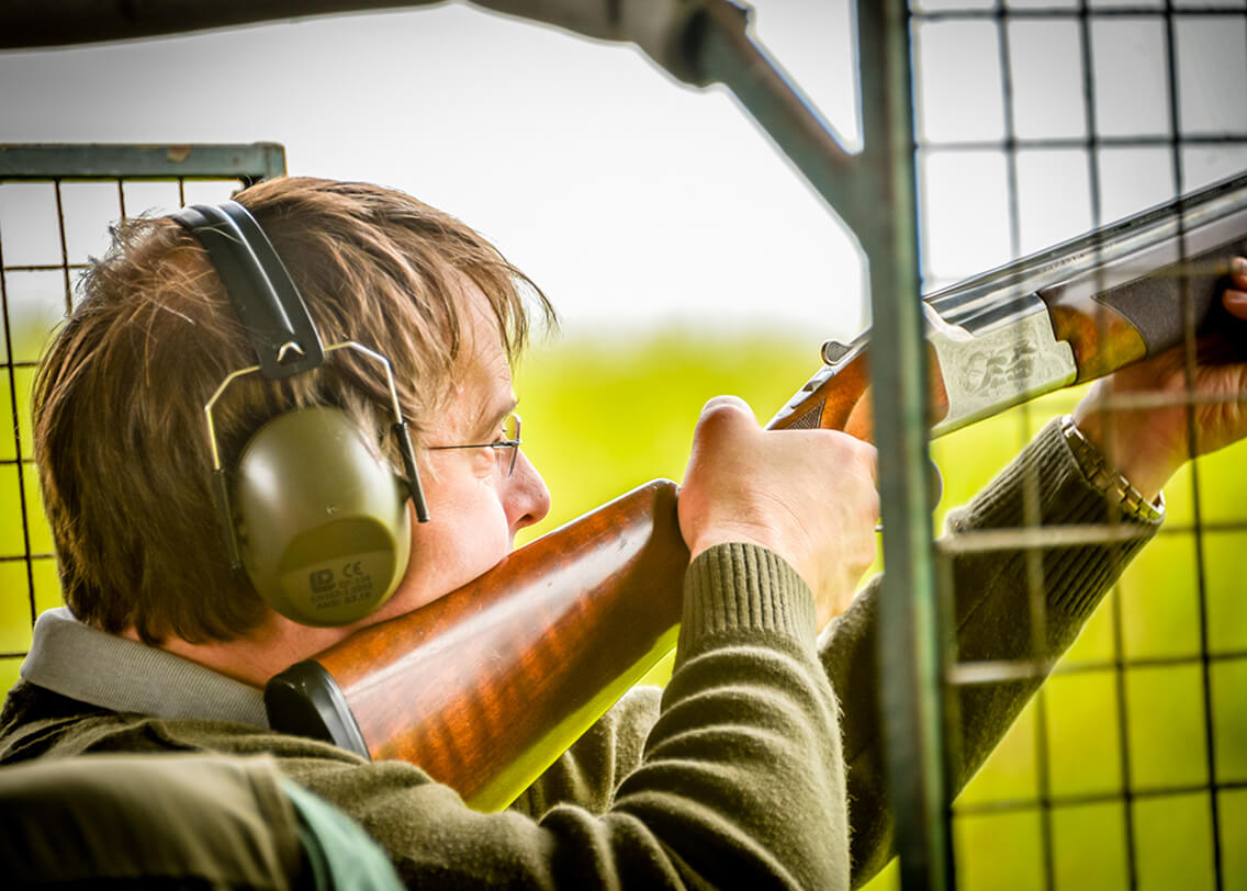 A member at Wedgnock Shooting Ground aiming down his shotgun