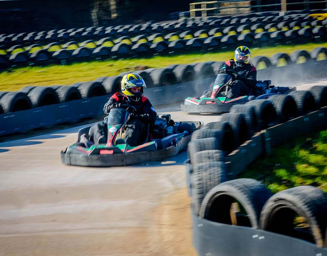A couple of go karts racing around a track