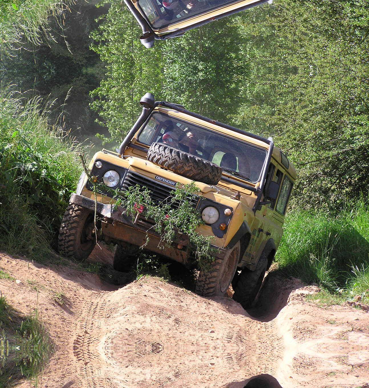 A land rover driving through difficult terrain