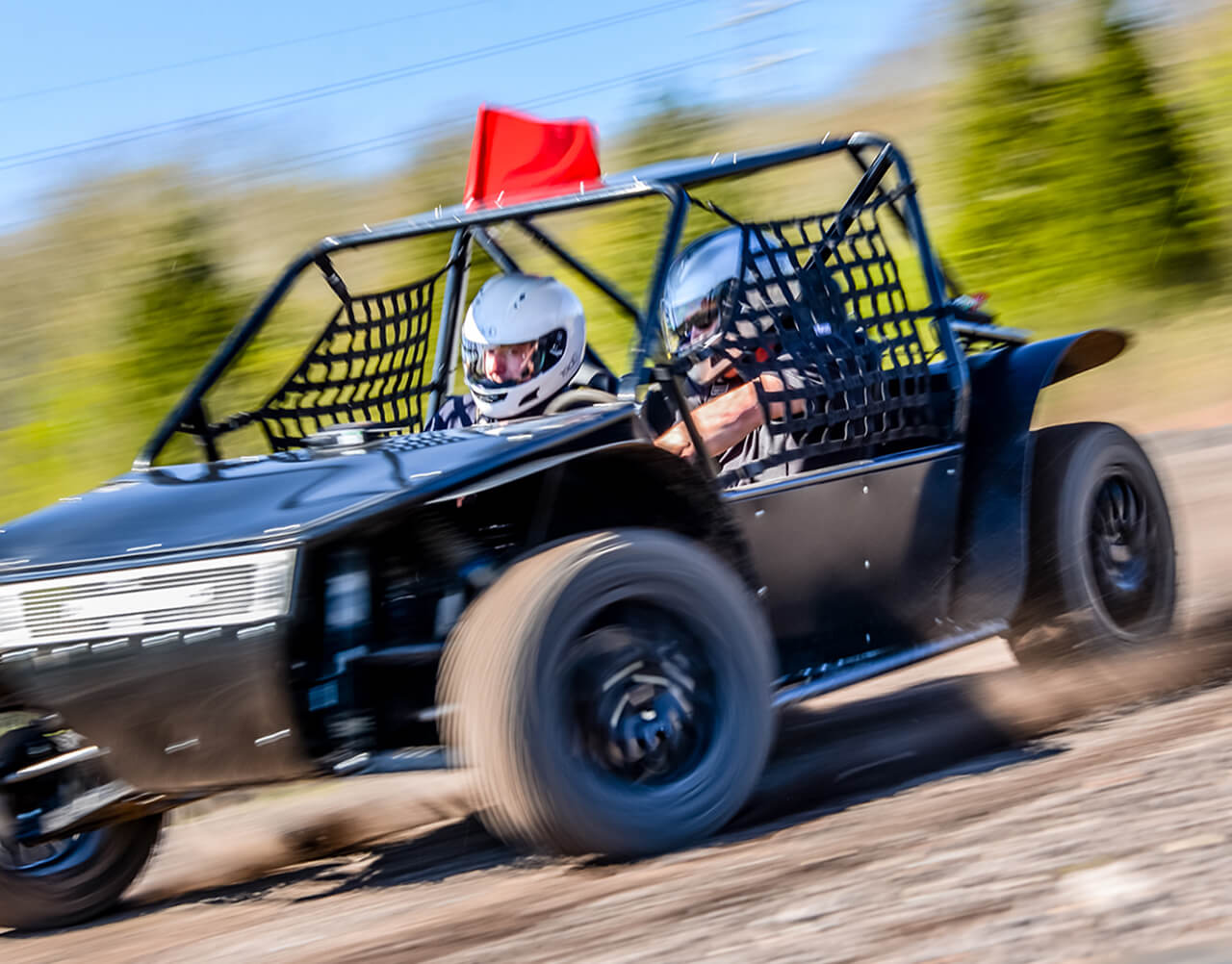 An off-road rally car driving around a course