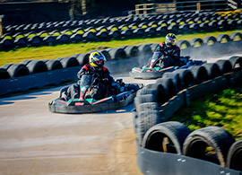 A couple of go karts racing around a track