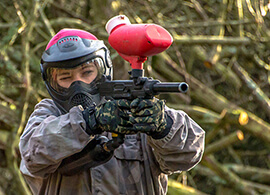 Someone aiming a paintball gun