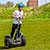 A boy driving a segway leaning forwards