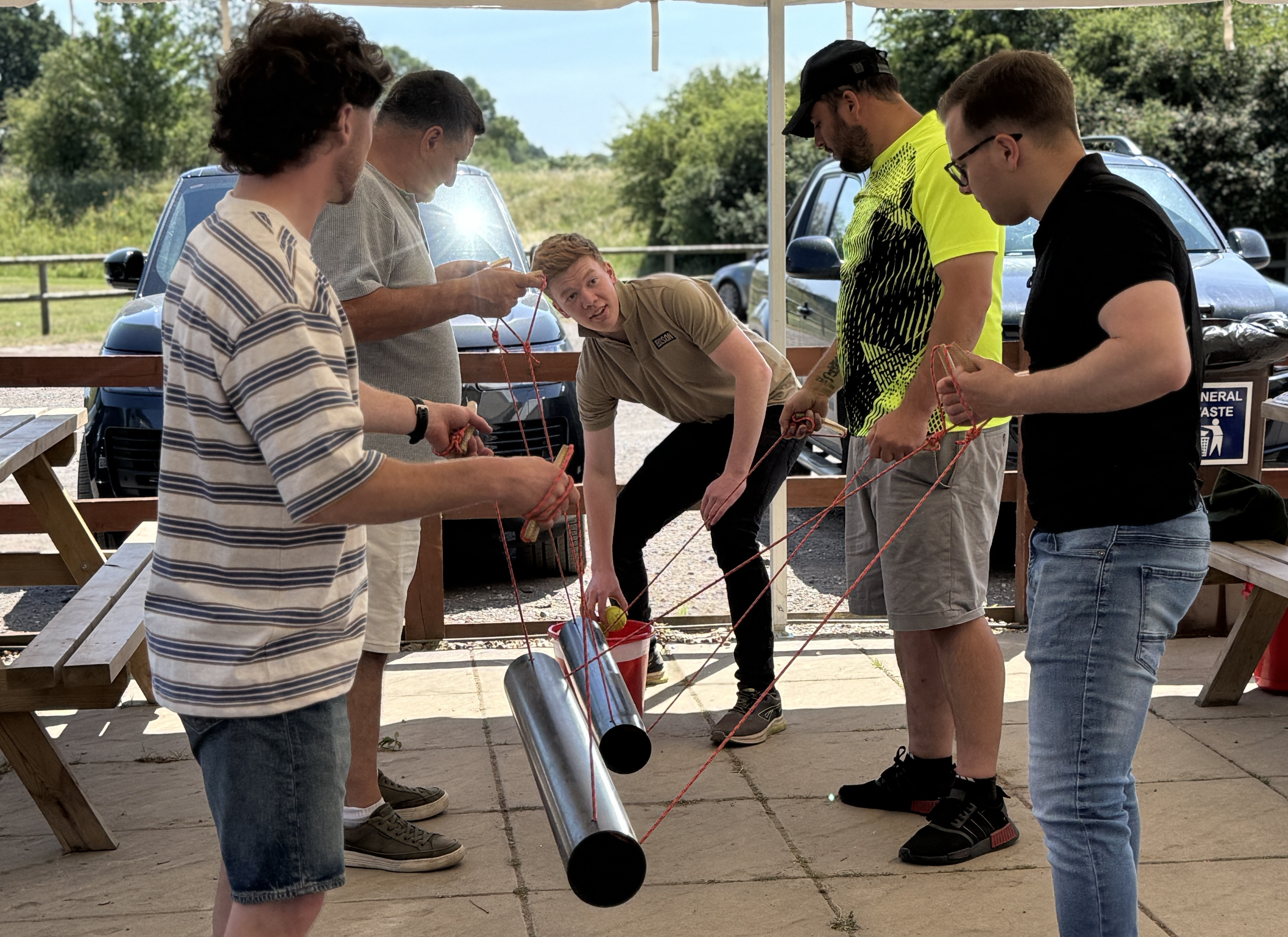Team Members working together to solve a challenge called Lever Crossing