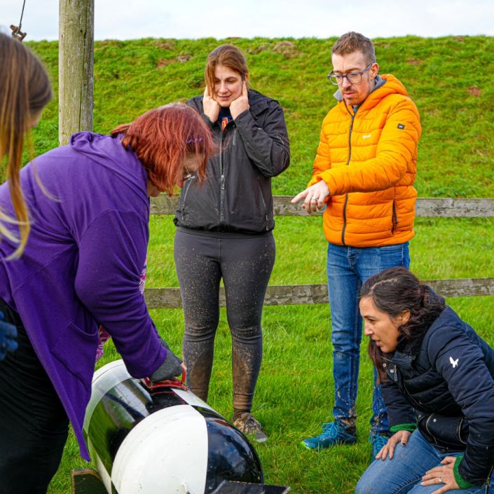 Corporate team working together on an outdoor team building challenge at Adventure Sports in Warwick
