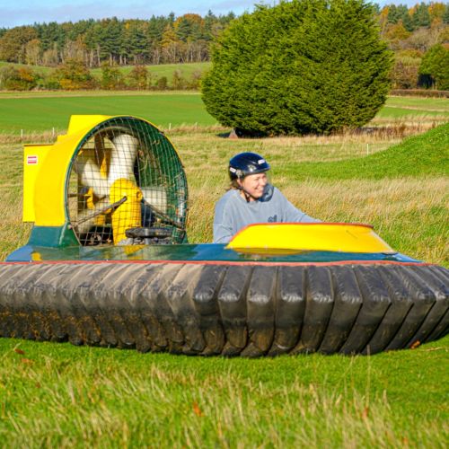 Participant driving a hovercraft during an outdoor corporate team building activity at Adventure Sports in Warwick