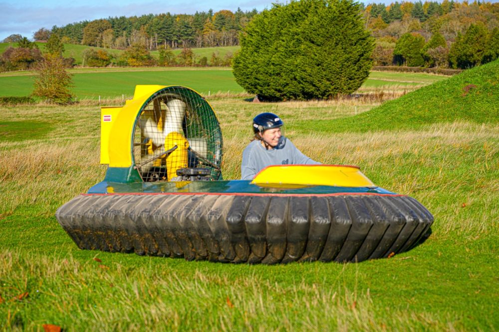 Participant driving a hovercraft during an outdoor corporate team building activity at Adventure Sports in Warwick