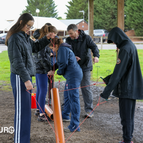 Group communicating and working together during an outdoor team building challenge at Adventure Sports Warwick